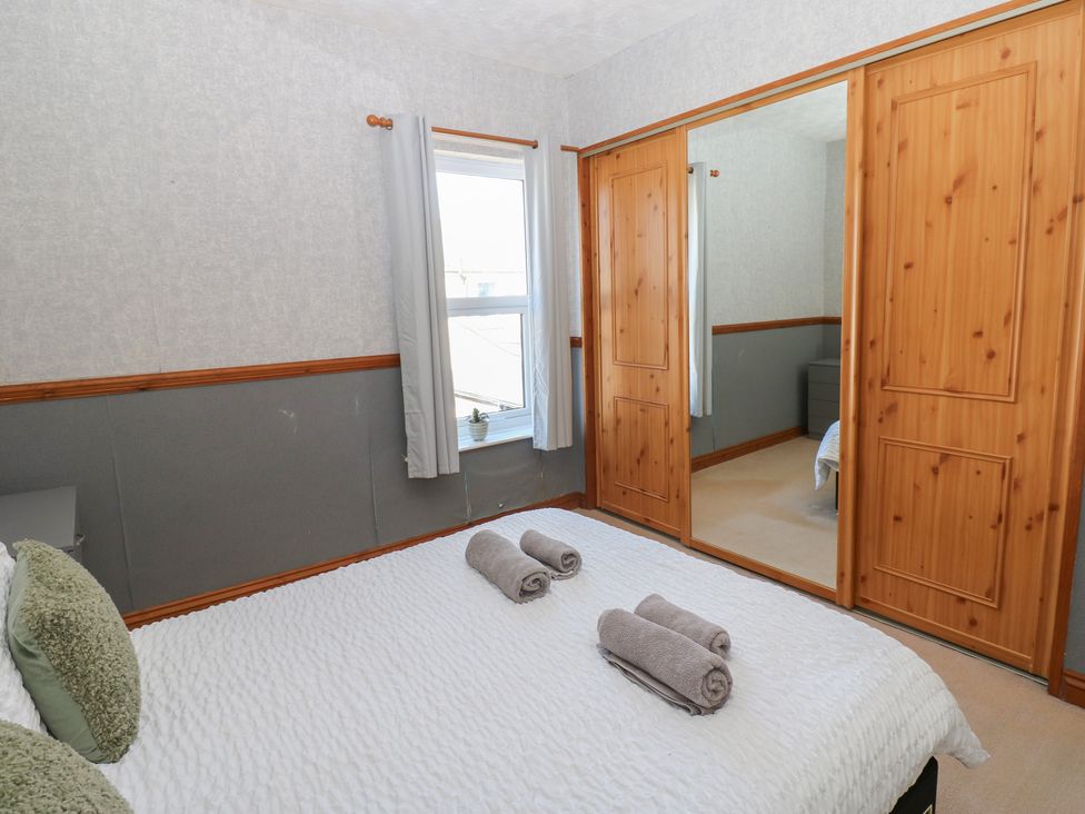 A bedroom with a bed and towels on it at Bolton Terrace in Workington