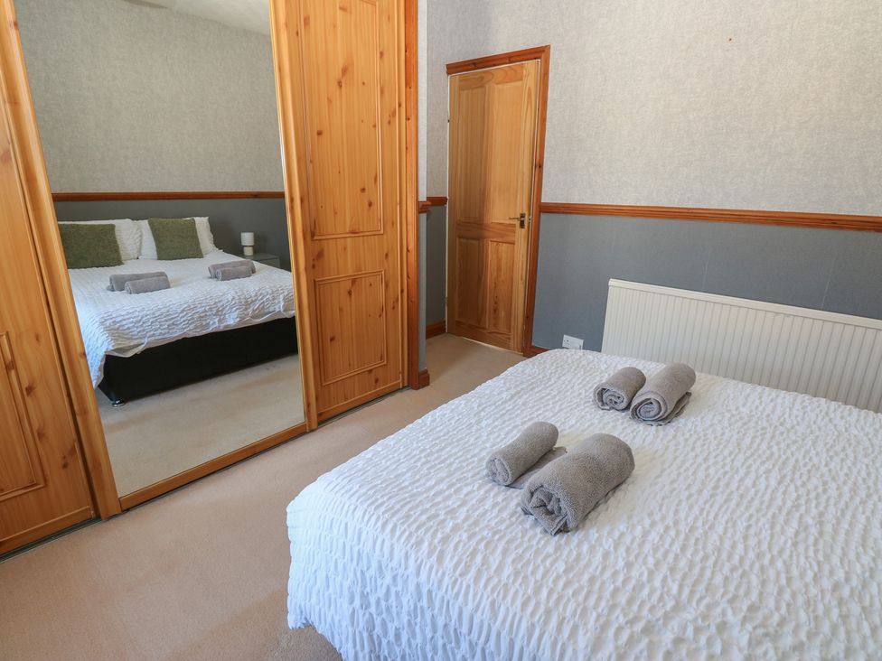 A bedroom with a bed and towels on it at Bolton Terrace in Workington