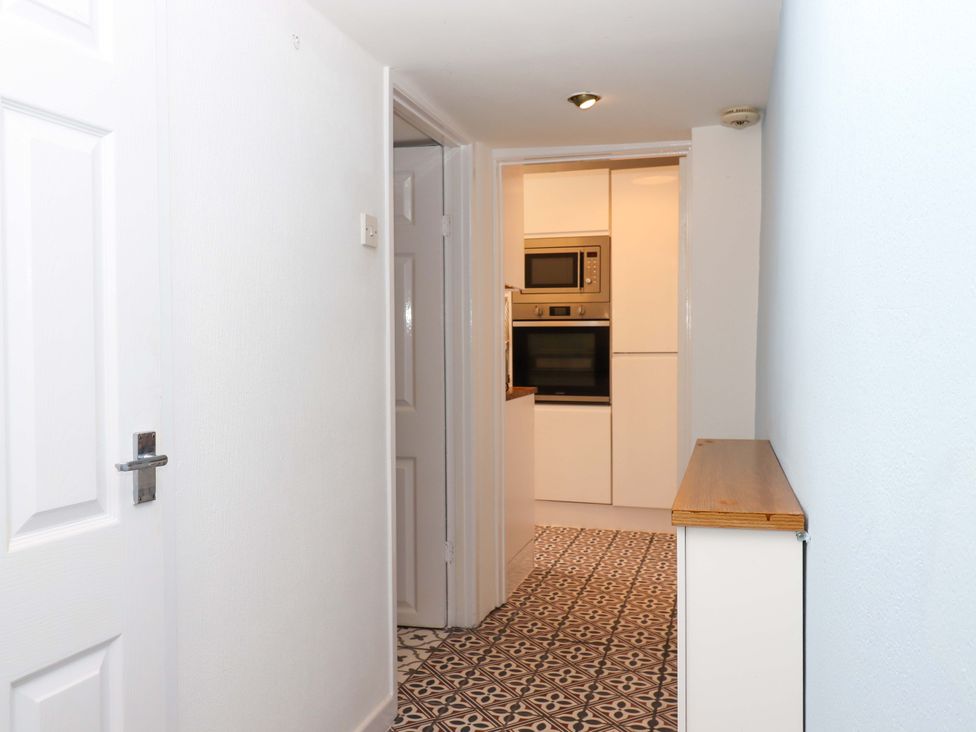 A hallway leading to a kitchen at Kenny Cottage in Dawlish