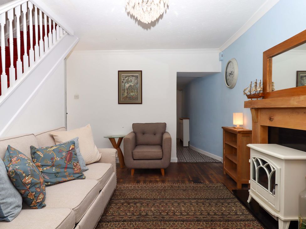 A living room with a sofa and armchair at Kenny Cottage in Dawlish