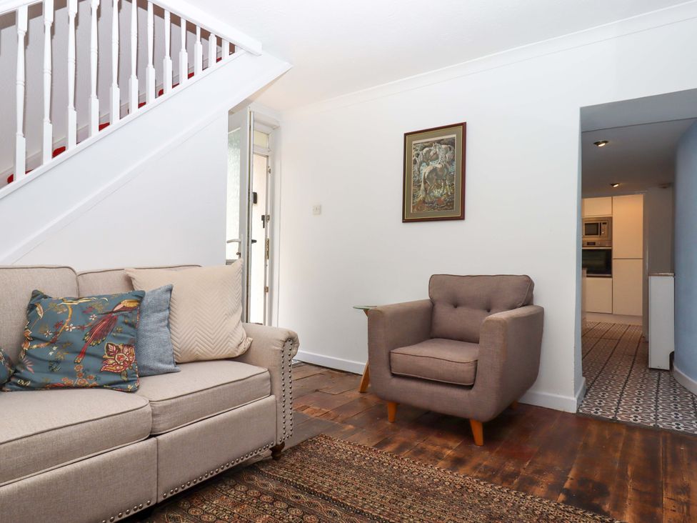 A living room with a sofa and chair at Kenny Cottage in Dawlish