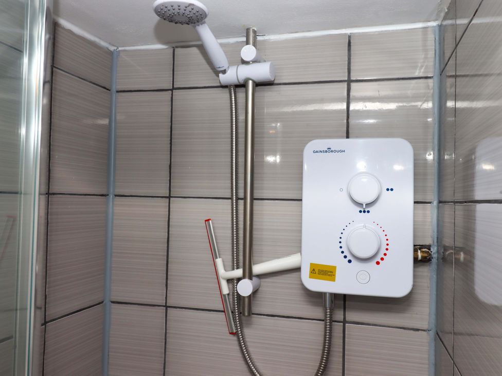 A shower system with a shower head and valve in Kenny Cottage Dawlish