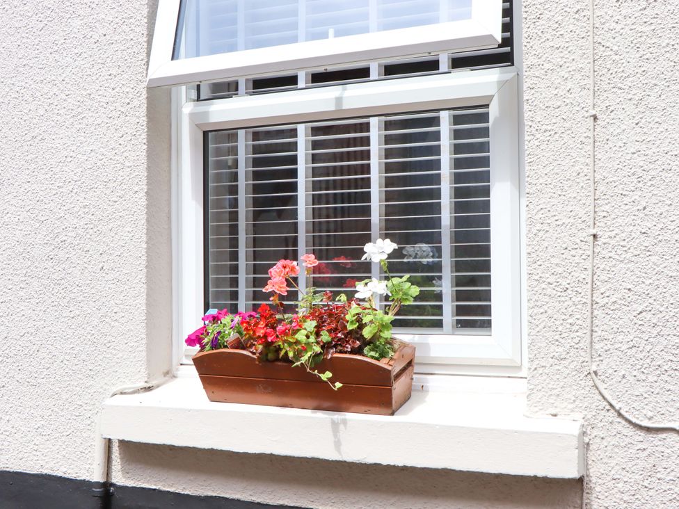A window with a flower box at Kenny Cottage, Dawlish
