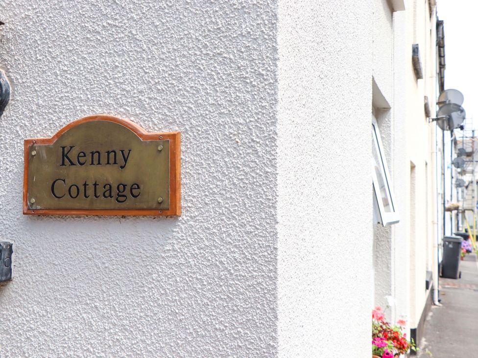 A sign with the name Kenny Cottage on a wall in Dawlish