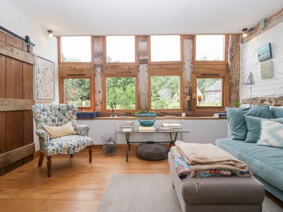 A living room with a sofa and armchair at The Art House in Leominster