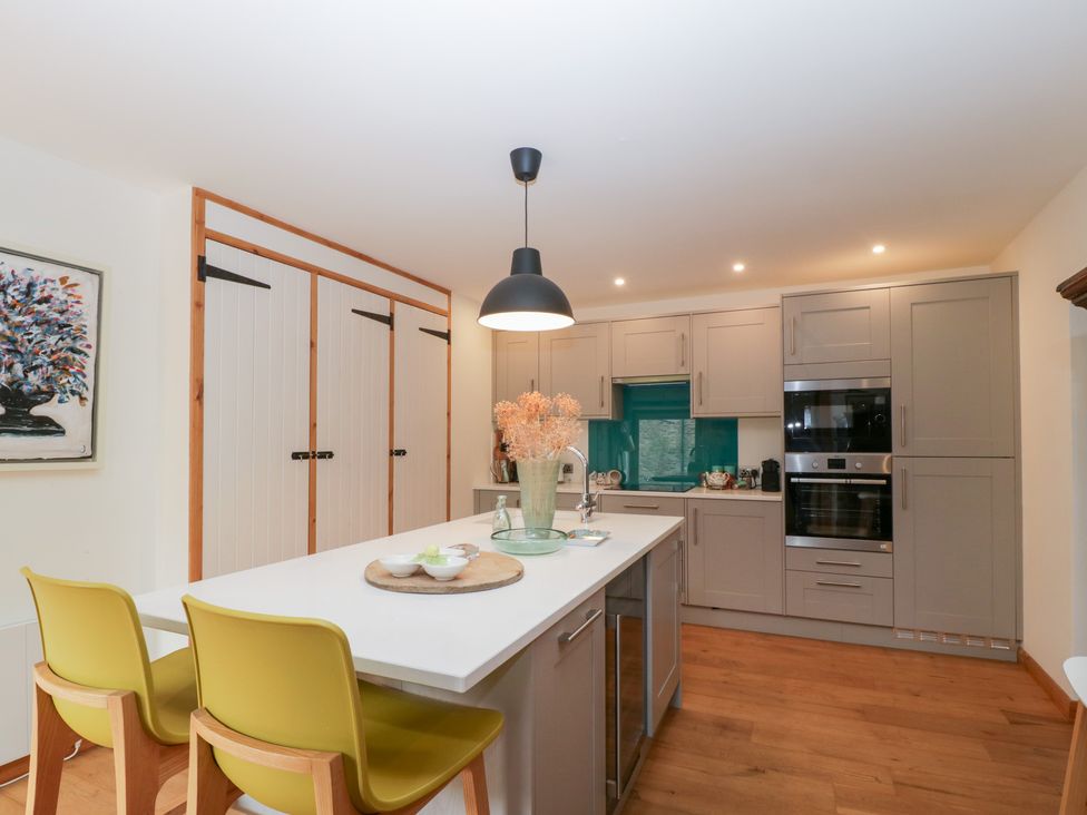 A kitchen with kitchen island and wall cabinets at The Art House in Leominster
