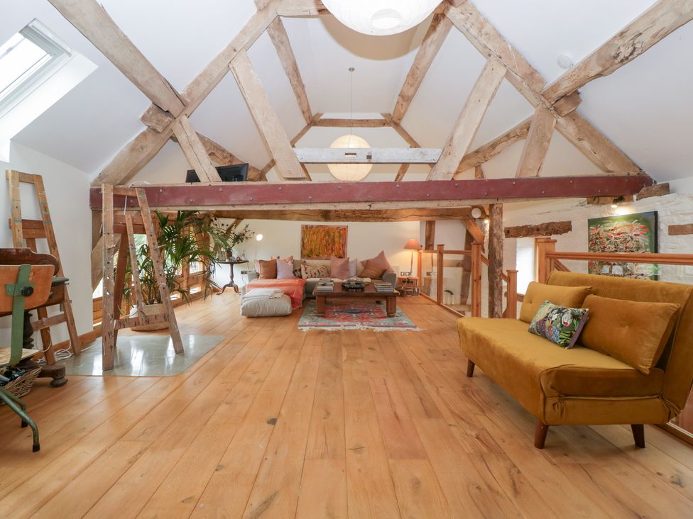 A loft with a sofa and coffee table at The Art House in Leominster