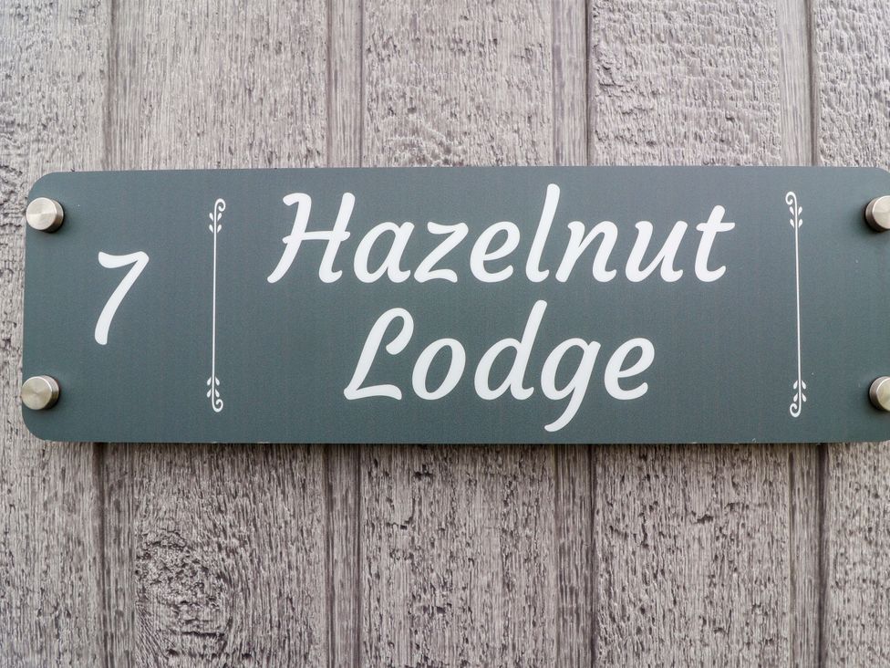 A house sign displaying the number 7 and Hazelnut Lodge at Hazelnut Lodge in Chipping Norton