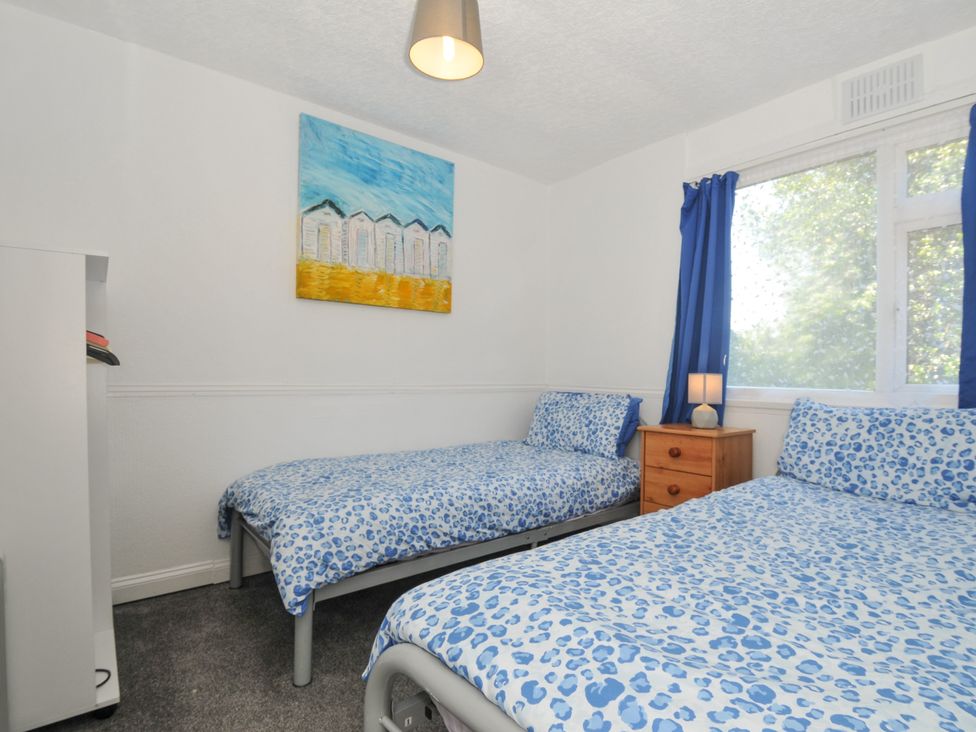A bedroom with two beds and a bedside table at 8 Hillside in Bude