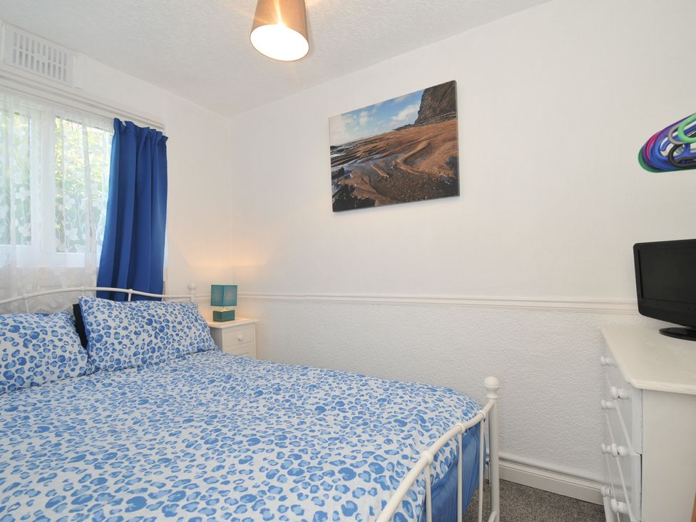 A bedroom with a bed and a bedside table at 8 Hillside in Bude