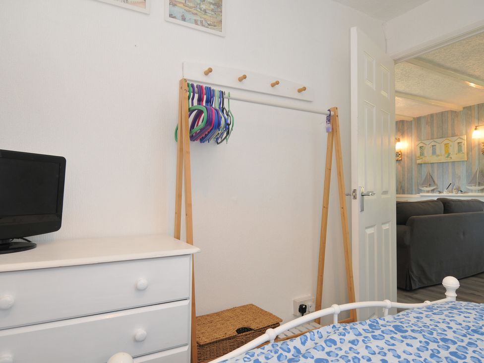 A bedroom with a dresser and hangers at 8 Hillside Bude
