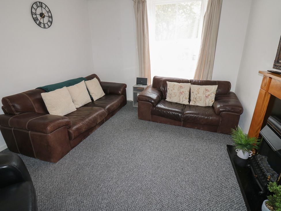 A living room with sofas and a clock at Georgian Town House Whitehaven