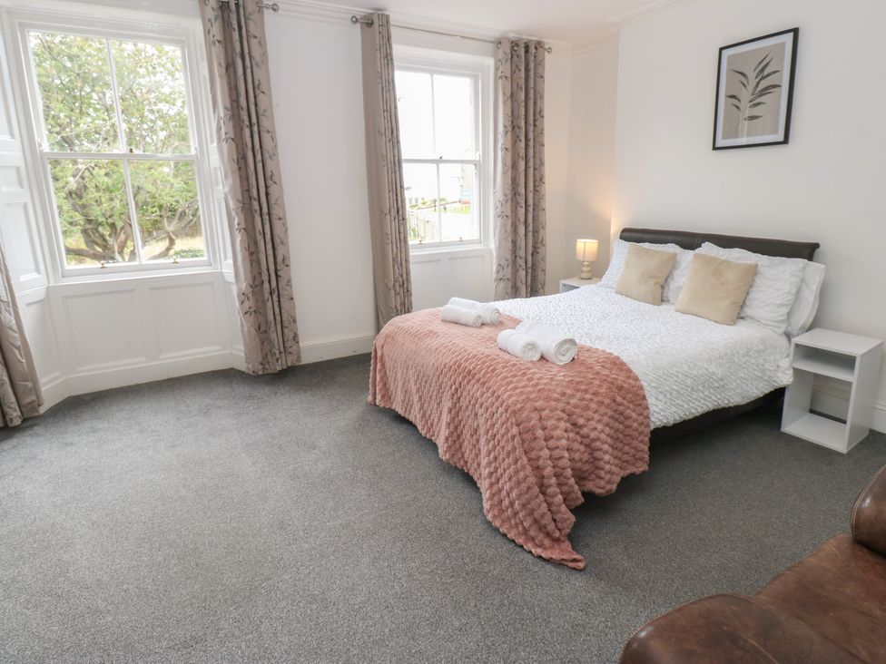A bedroom with a bed and bedside table at Georgian Town House in Whitehaven
