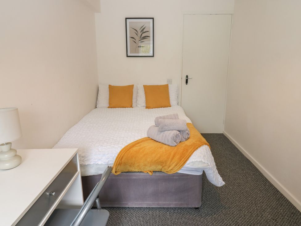 A bedroom with a bed and a desk at Georgian Town House in Whitehaven