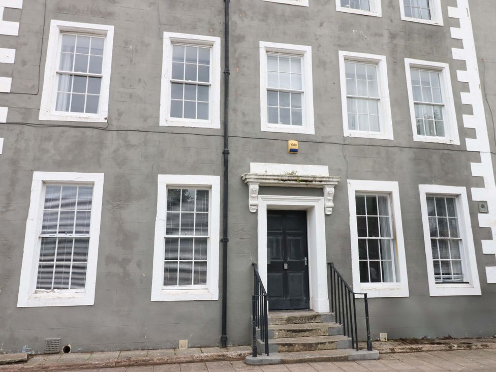 A building facade with windows and a door at Lowther Suite in Whitehaven