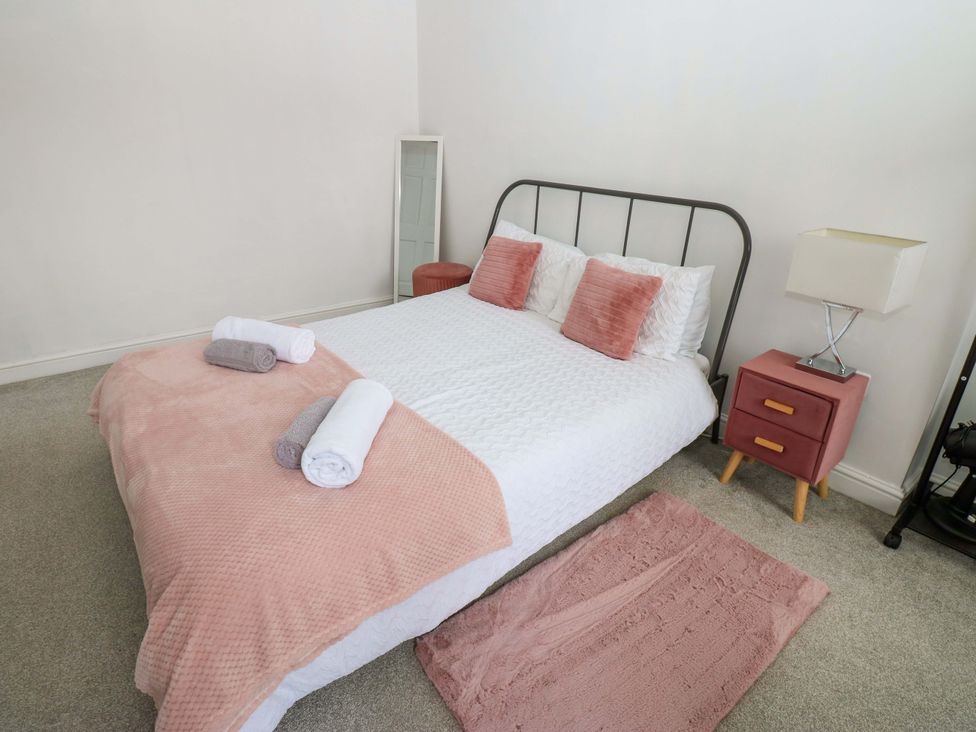A bedroom with a bed and a lamp at Lowther Suite in Whitehaven