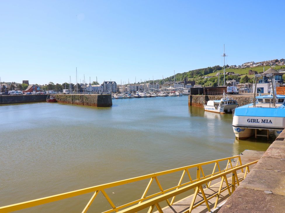 A marina with boats and a pier at Lowther Suite in Whitehaven