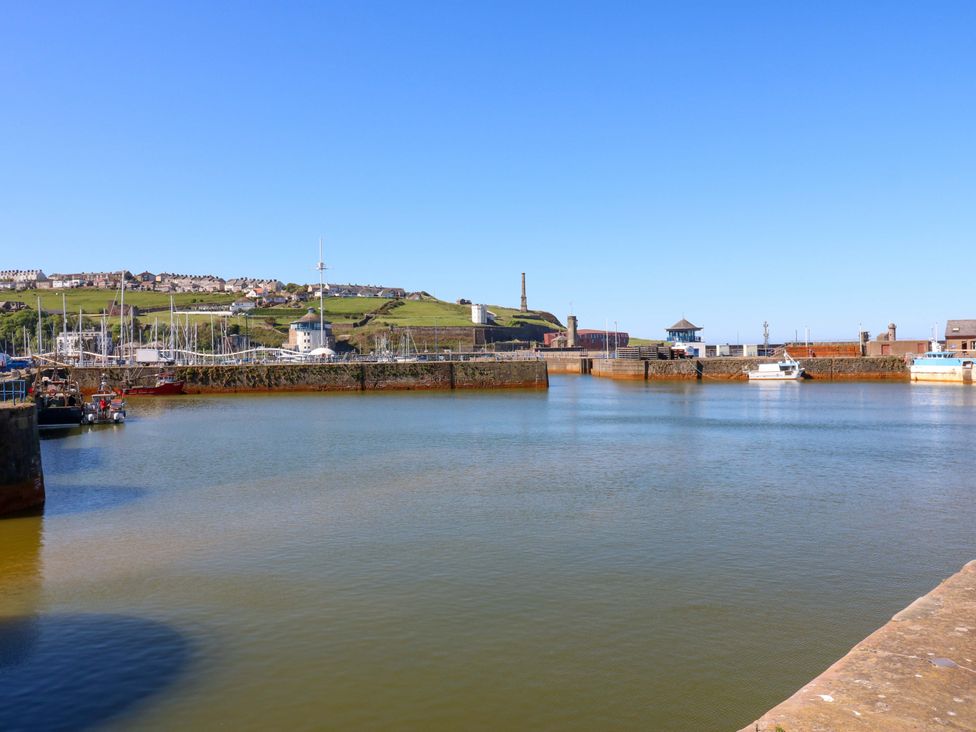 A harbor with boats and buildings at Lowther Suite in Whitehaven