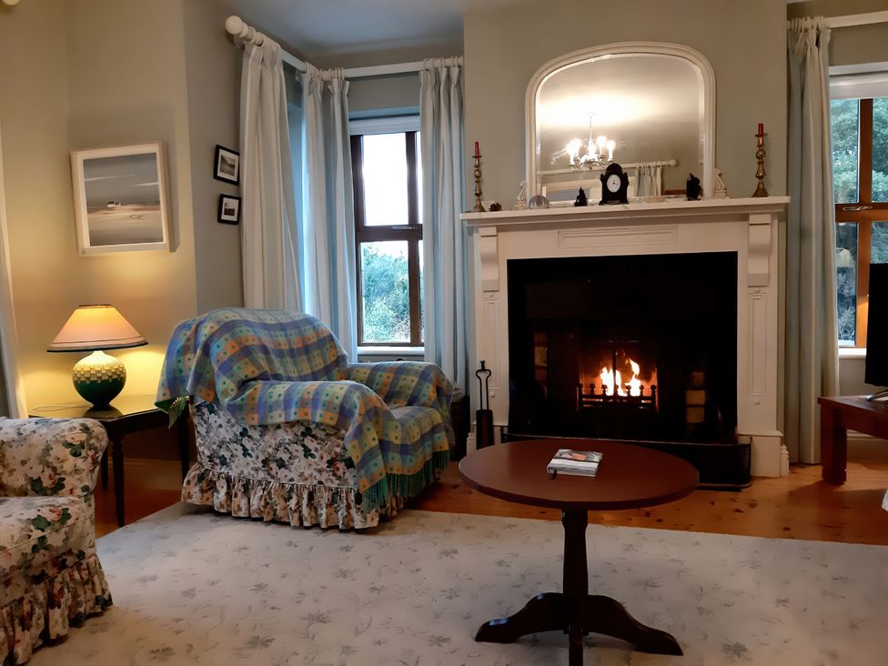 A living room with a fireplace and furniture at Moynish Mor Mulranny in MULRANNY