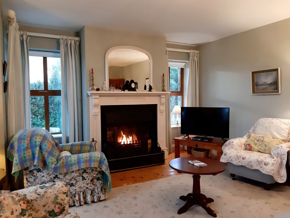 A living room with a fireplace and television at Moynish Mor Mulranny MULRANNY