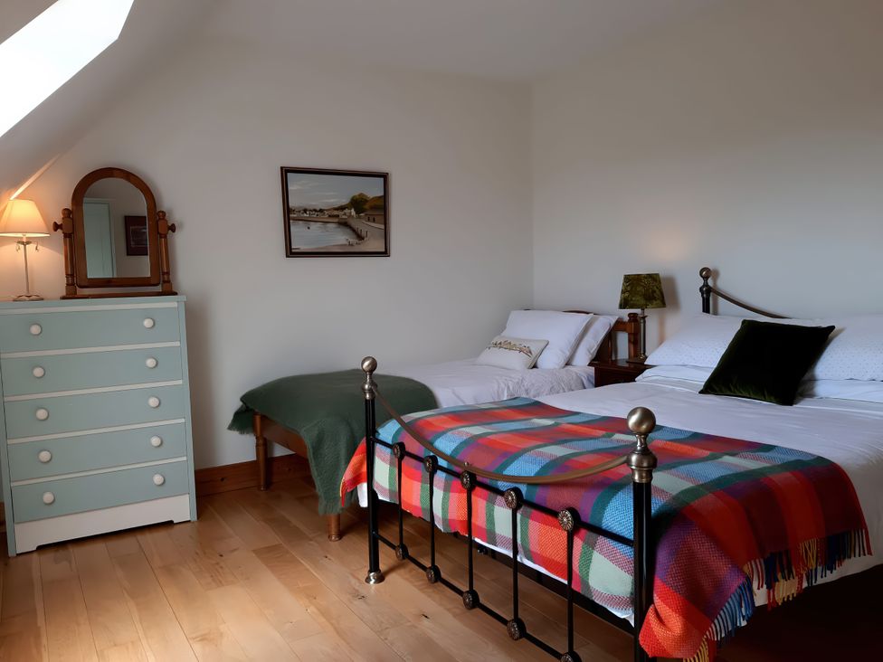 A bedroom with two beds and a dresser at Moynish Mor Mulranny in MULRANNY