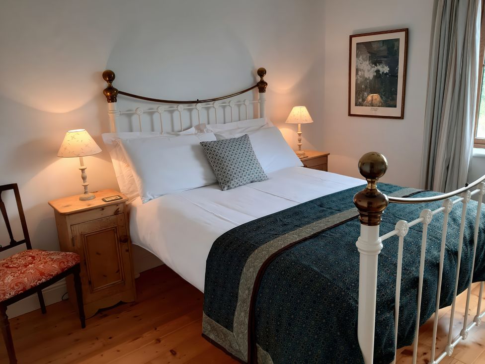 A bedroom with a bed and bedside table at Moynish Mor Mulranny in MULRANNY