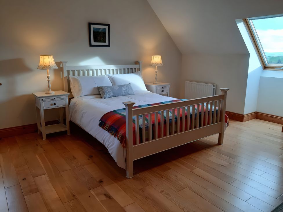 A bedroom with a bed and bedside tables at Moynish Mor Mulranny MULRANNY