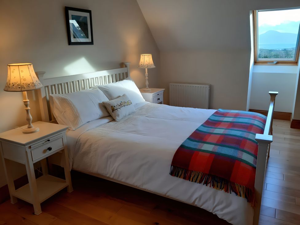 A bedroom with a bed and nightstand at Moynish Mor Mulranny MULRANNY