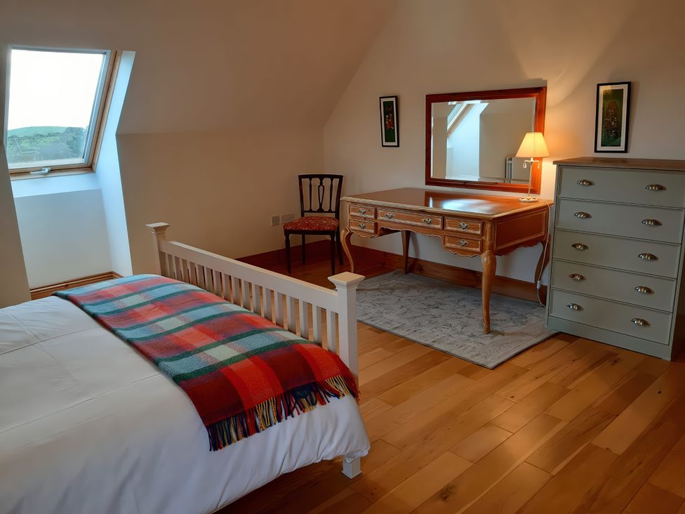A bedroom with a bed, desk, chair, and mirror at Moynish Mor Mulranny MULRANNY