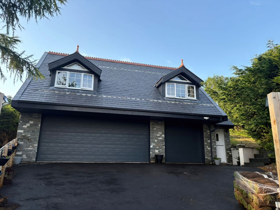 A house with garage doors and windows at Skerry Vore in Llandudno Junction