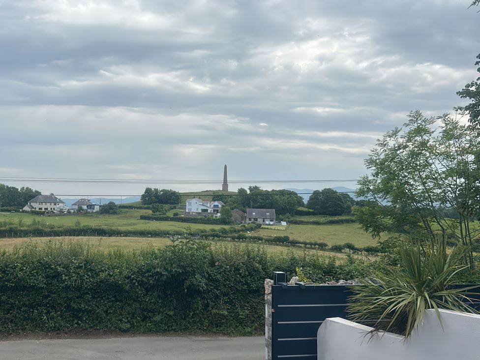 A view of houses and a monument in a field at Skerry Vore Llandudno Junction