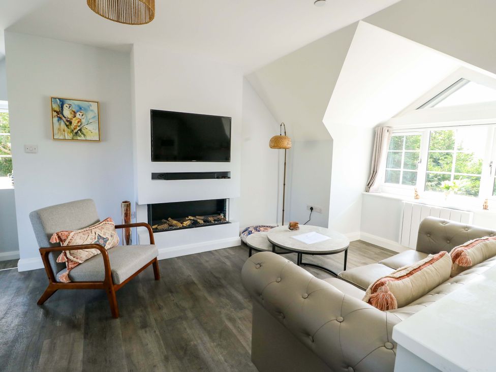 A living room with a sofa and a coffee table at The Gatekeepers Cottage - Skerry Vore, Bryn Pydew near Llandudno Junction