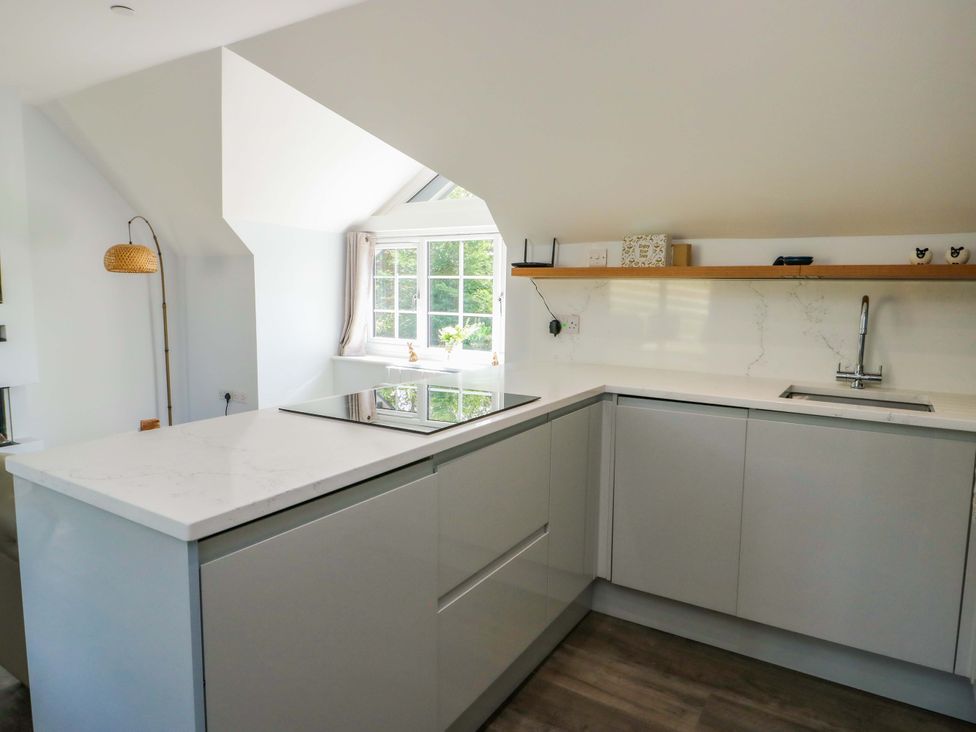 A kitchen with a sink and countertop at The Gatekeepers Cottage - Skerry Vore Bryn Pydew near Llandudno Junction