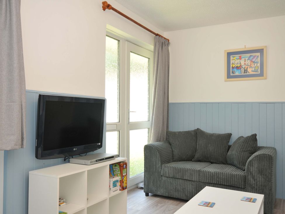 A living room with television and sofa at 4 Rosecraddoc Lodge Holiday Bungalows Liskeard
