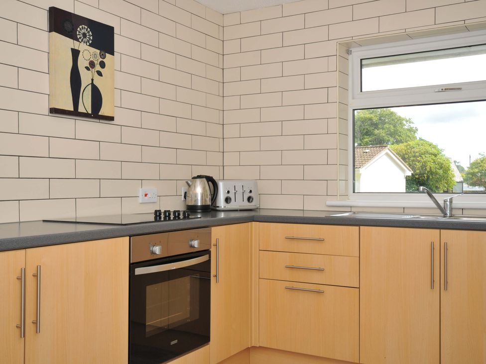 A kitchen with a kettle, toaster, and oven at 4 Rosecraddoc Lodge Holiday Bungalows, Liskeard