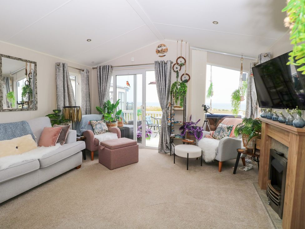 A living room with a sofa and television at No. 2 - Seaview in Kessingland