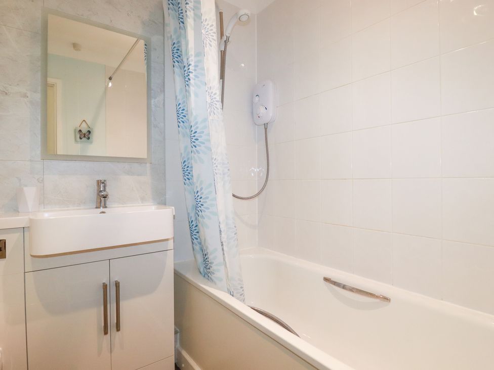 A bathroom with a sink, bathtub, and shower at Trouts Reach in Falmouth