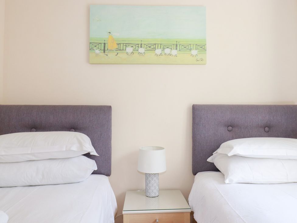 A bedroom with two beds and a nightstand at Trouts Reach in Falmouth