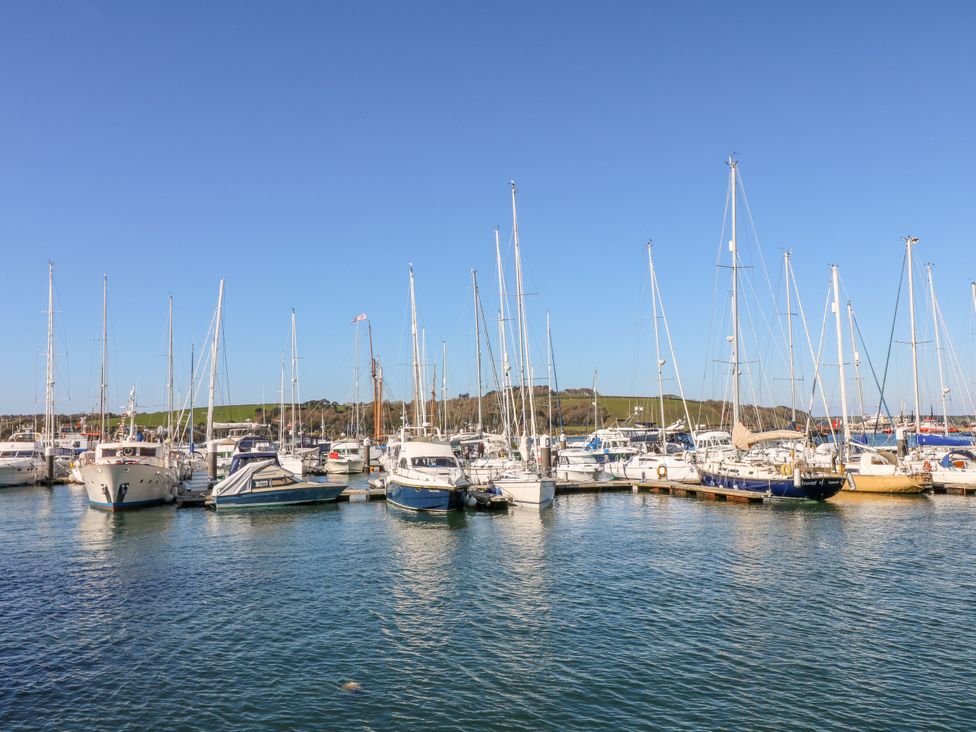 A marina with multiple boats docked at Trouts Reach Goldenbank near Budock Water