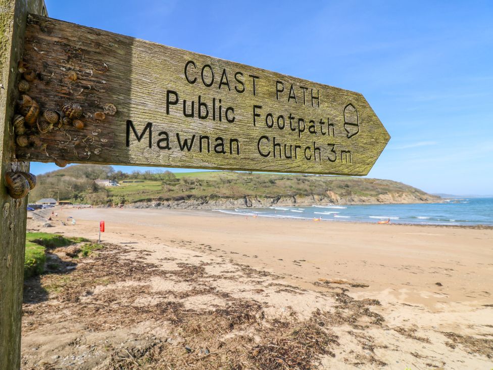 A sign directing to Mawnan Church from the coast path at Trouts Reach in Goldenbank near Budock Water