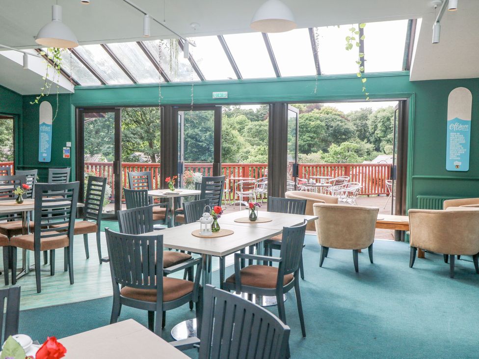 A dining room with tables and chairs at Trouts Reach in Goldenbank near Budock Water