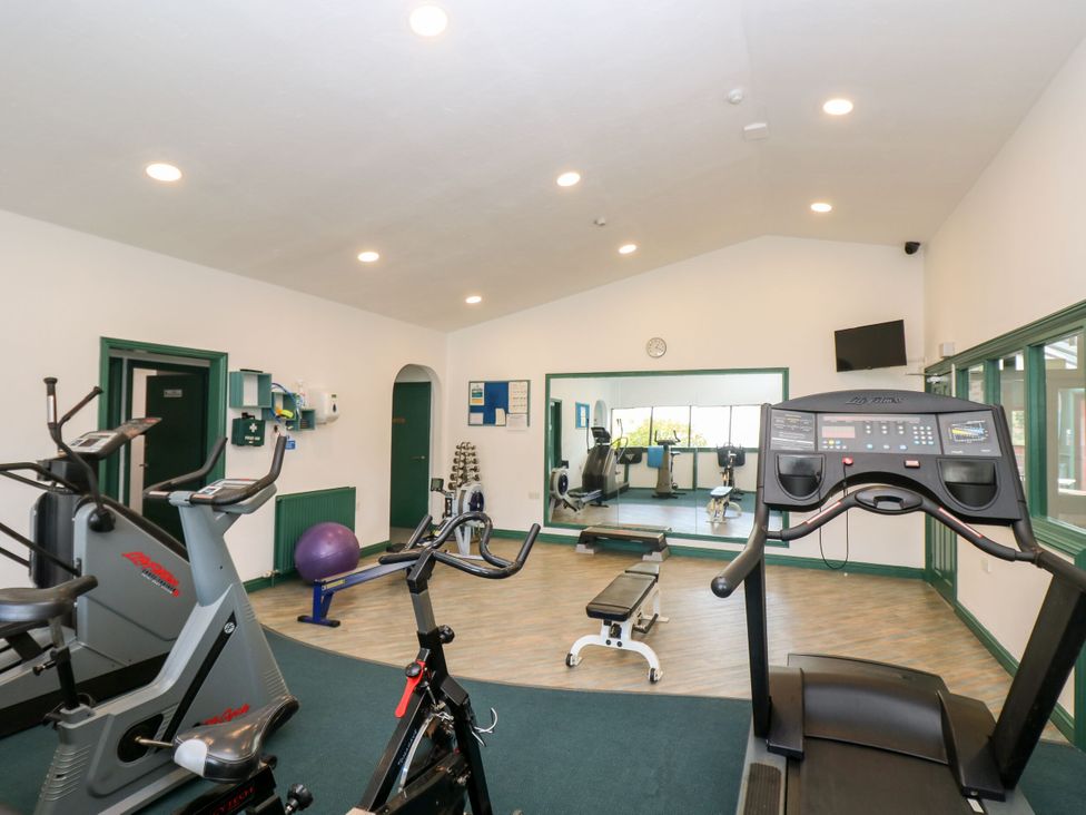 A gym with exercise bikes and a treadmill at Trouts Reach in Goldenbank near Budock Water