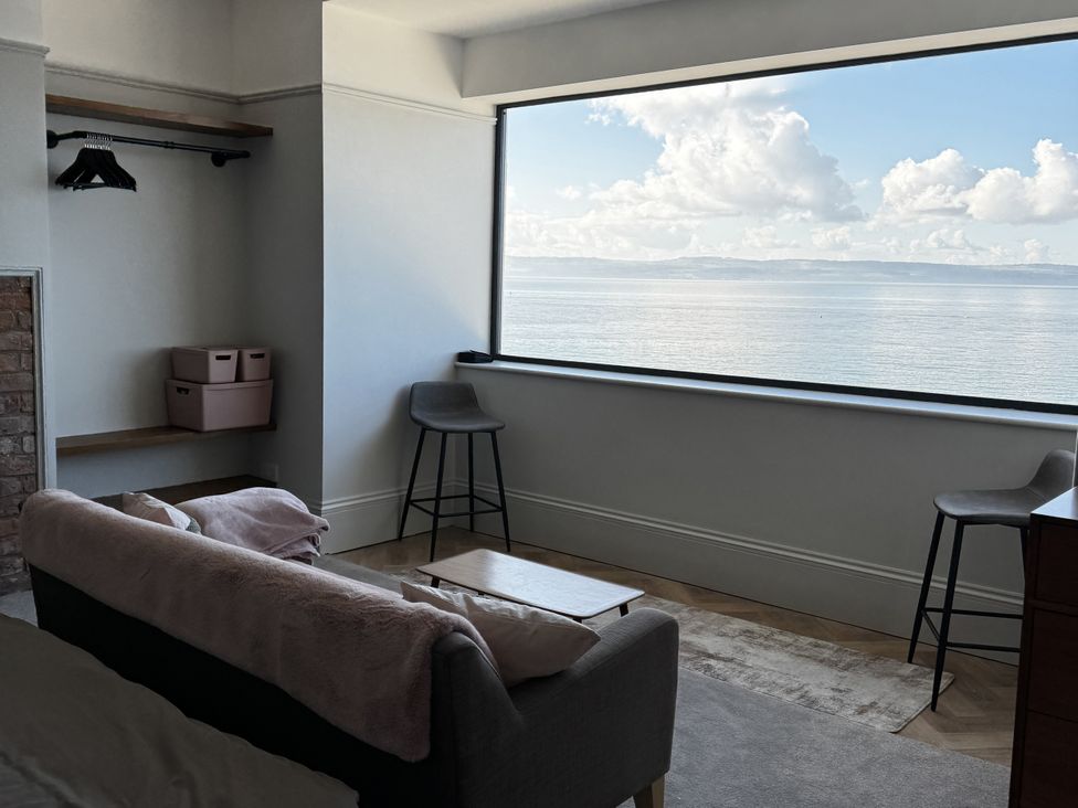 A living room with a view of the sea at Mostyn View in West Kirby