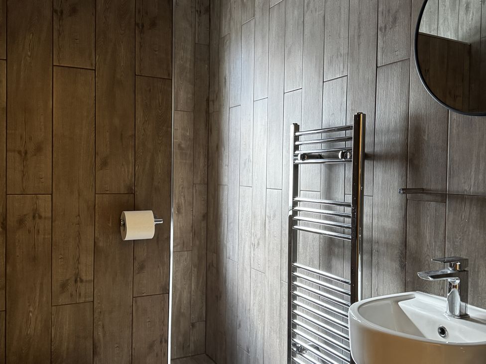 A bathroom with a wash basin and towel radiator at Mostyn View in West Kirby