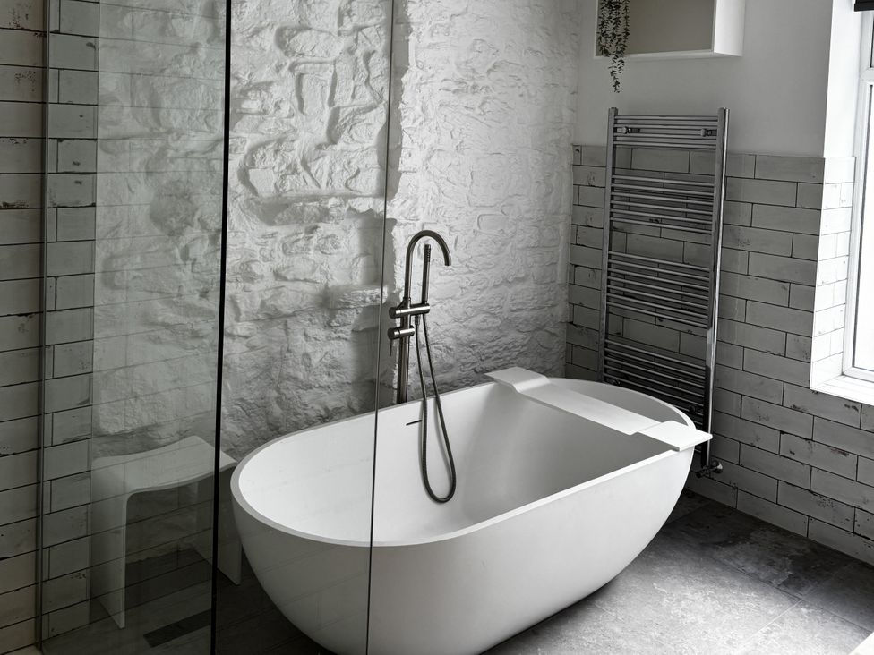 A bathroom with a bathtub and a shower at Mostyn View in West Kirby