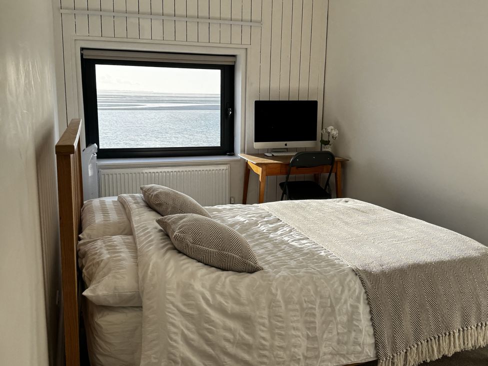 A bedroom with a bed and a desk at Mostyn View West Kirby