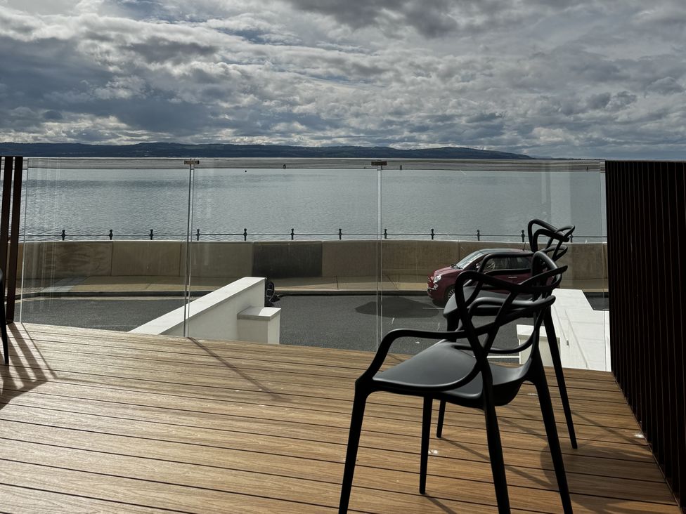 An outdoor area with chairs and a view of the water at Mostyn View in West Kirby