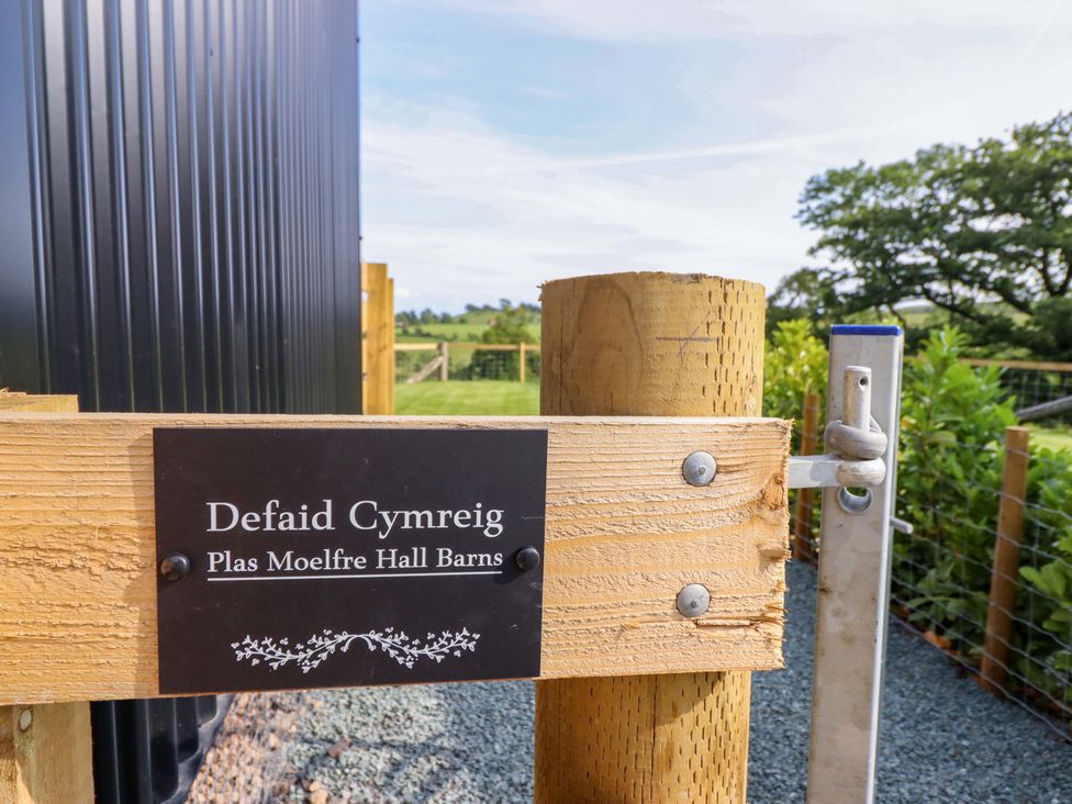 A sign on a wooden gate at Defaid Cymreig in Oswestry