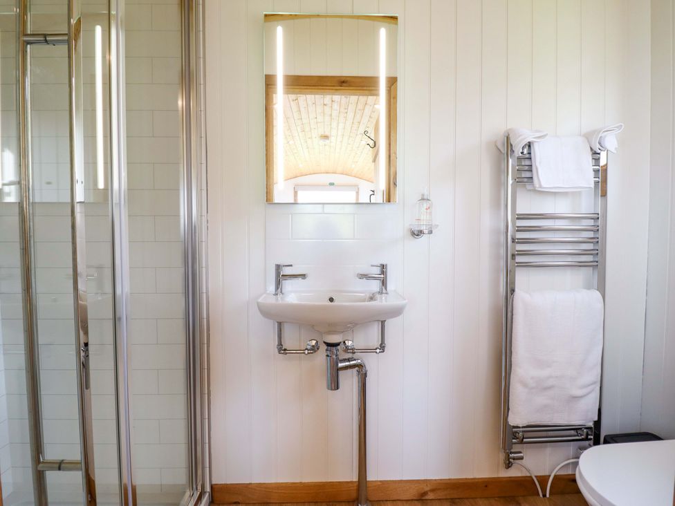 A bathroom with a sink and mirror at Defaid Cymreig Oswestry