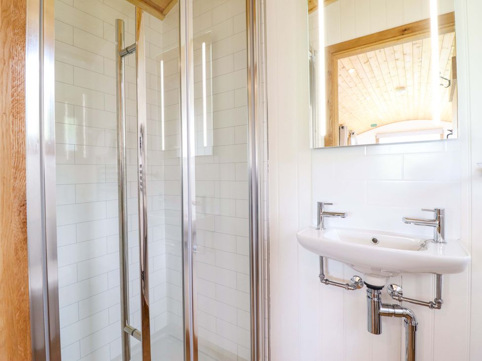A bathroom with a shower and sink at Defaid Cymreig in Oswestry